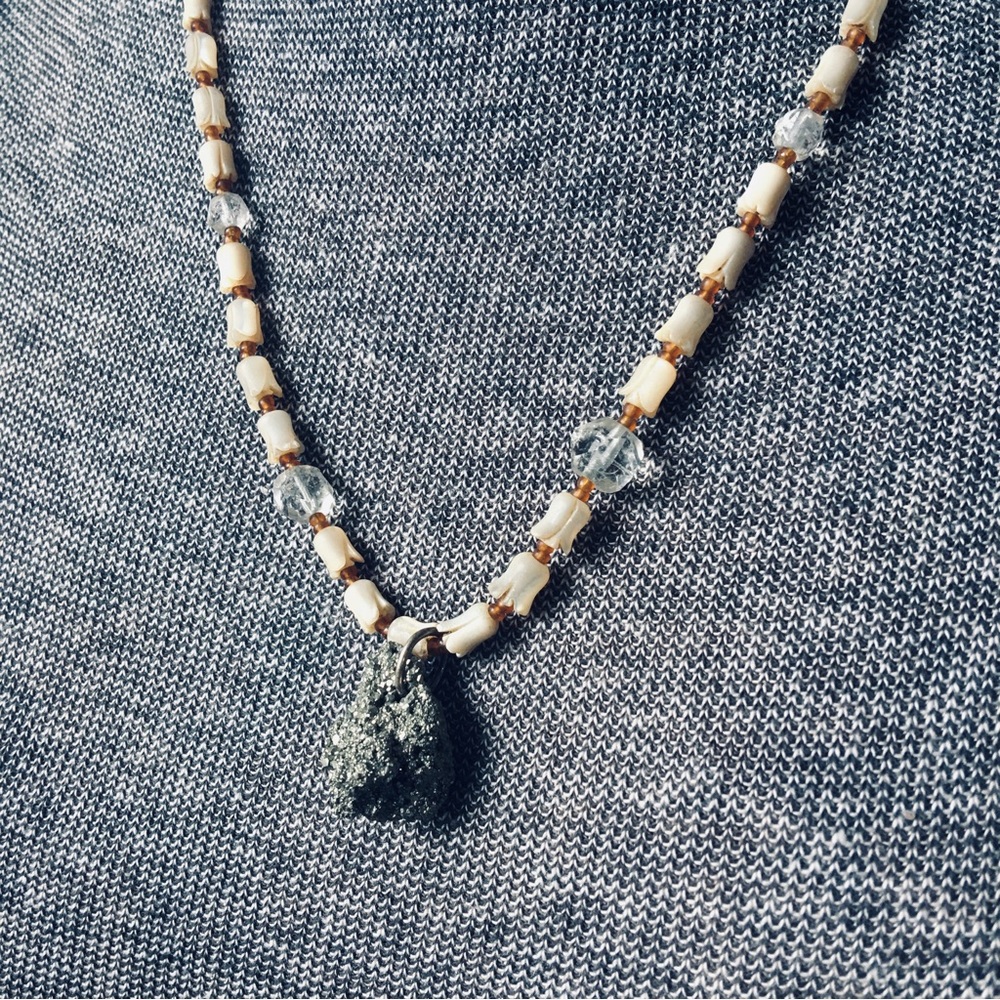 Necklace made with carved mother of pearl, hand cut crystal and fools gold